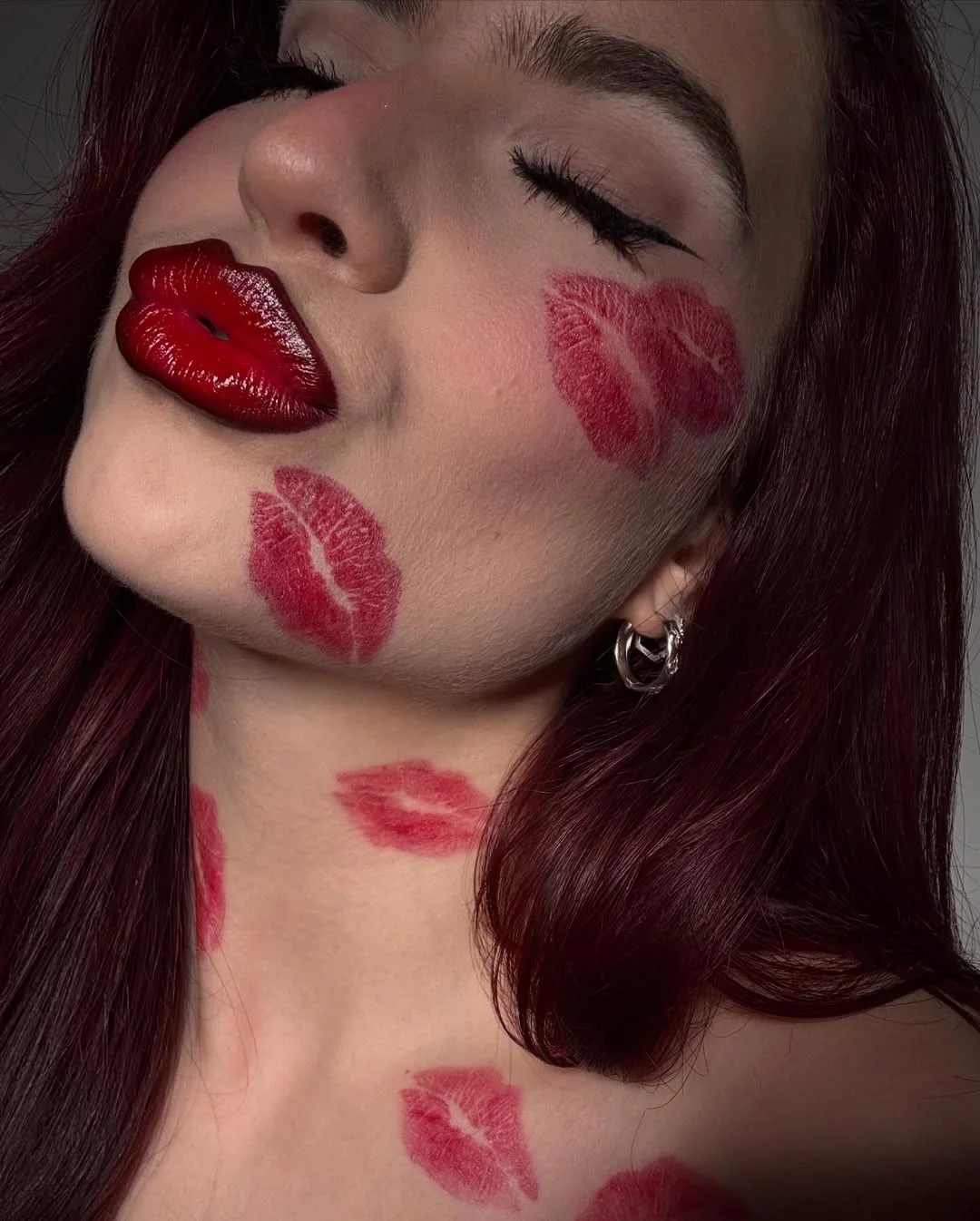 Photo by Abby Roberts on February 14, 2026. May be a closeup of one or more people, makeup, lipstick, people kissing and text.