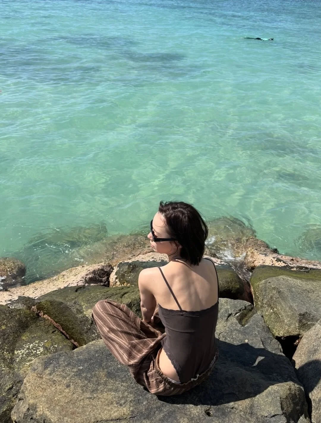 Photo by aespa 에스파 FANPAGE on February 19, 2026. May be an image of sarong, ocean, beach and text.