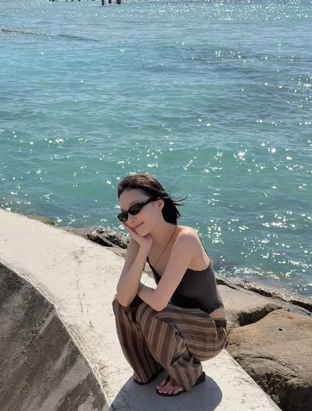 Photo by aespa 에스파 FANPAGE on February 19, 2026. May be an image of sarong, ocean, beach and text.