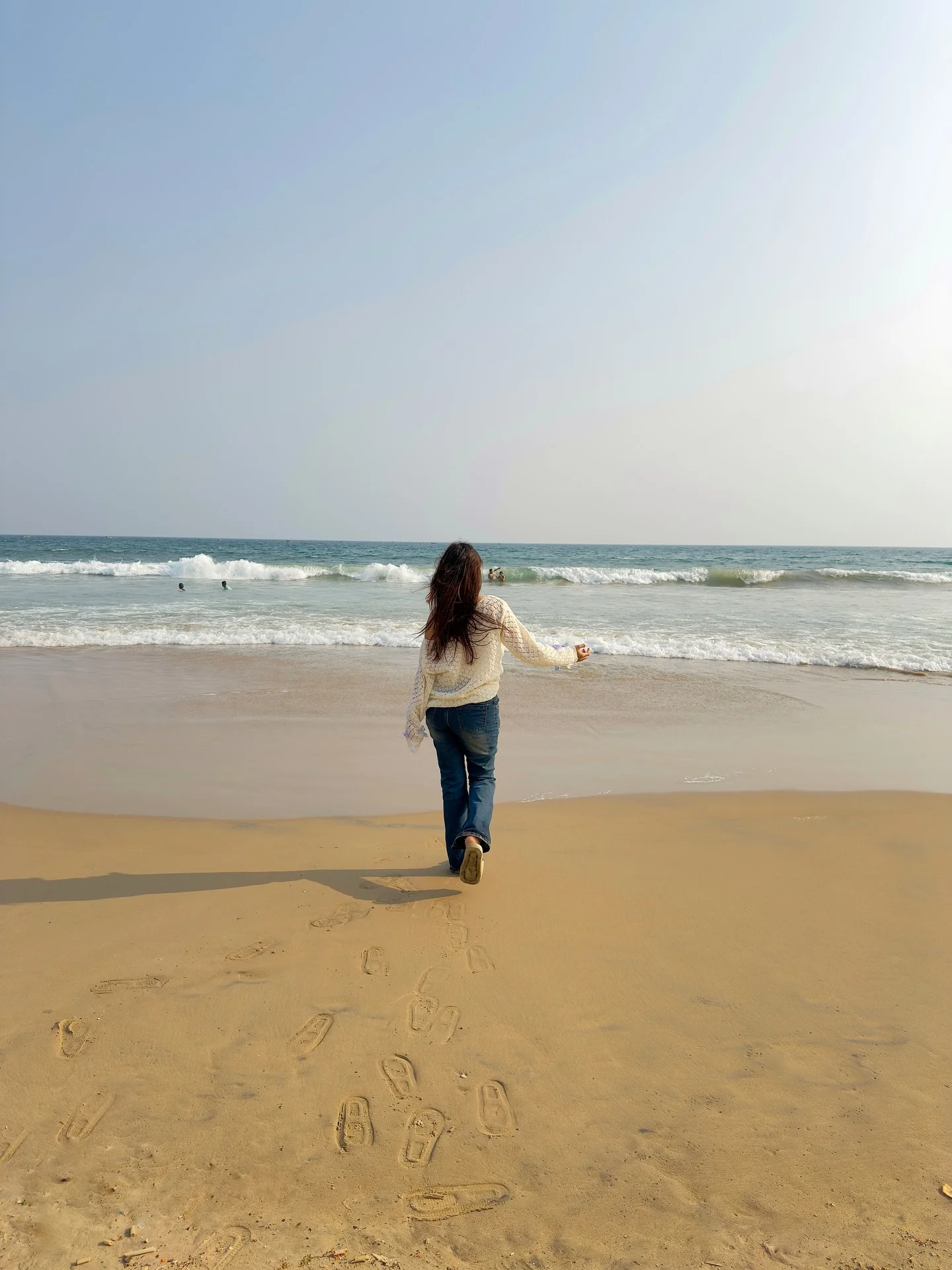 Photo by Aimi Gogoi on February 15, 2026. May be an image of standing, water, beach, horizon, ocean, coast and text.