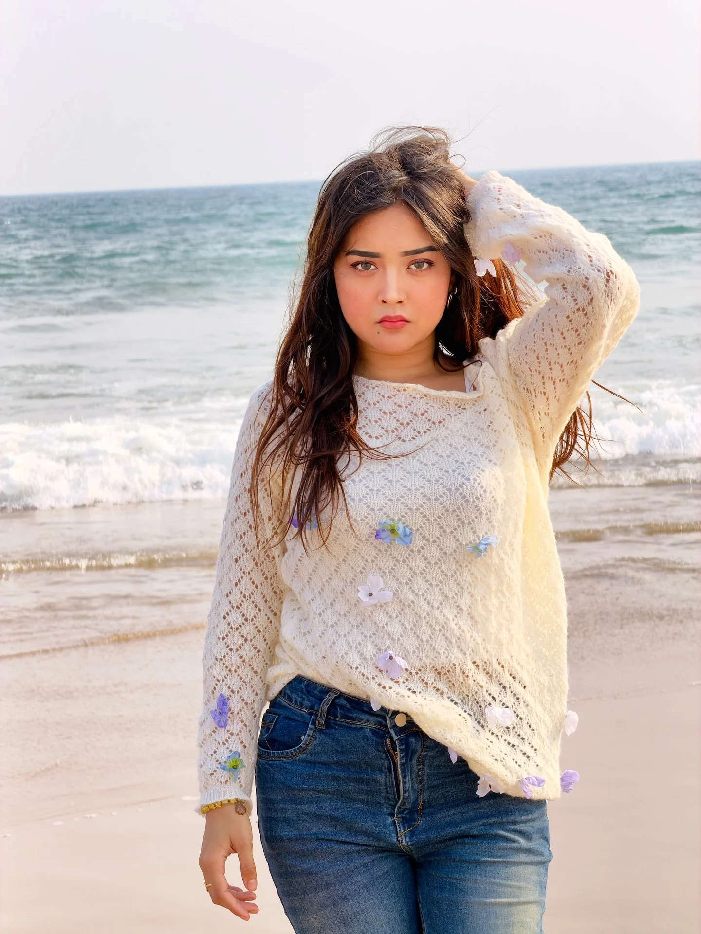 Photo by Aimi Gogoi on February 15, 2026. May be an image of one or more people, makeup, hair, top, fishnet stockings, beach and text.