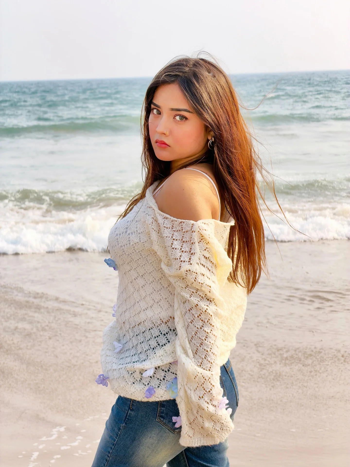 Photo by Aimi Gogoi on February 15, 2026. May be an image of one or more people, makeup, long hair, beach, ocean and text.