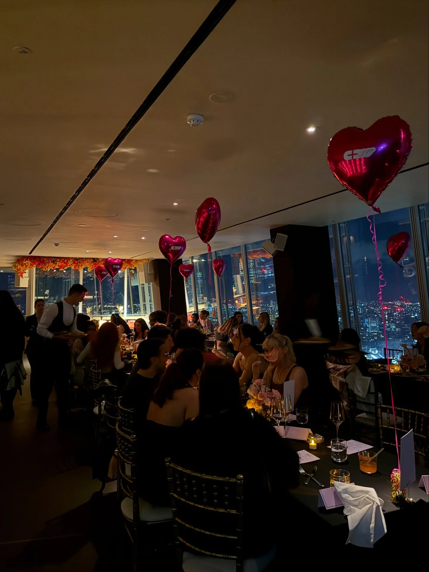 Photo shared by Amanda Sze 🥰 on February 18, 2026 tagging @oblixrestaurant, @culted, and @cultedxo. May be an image of lighting, heart, table, balloon, night and text.