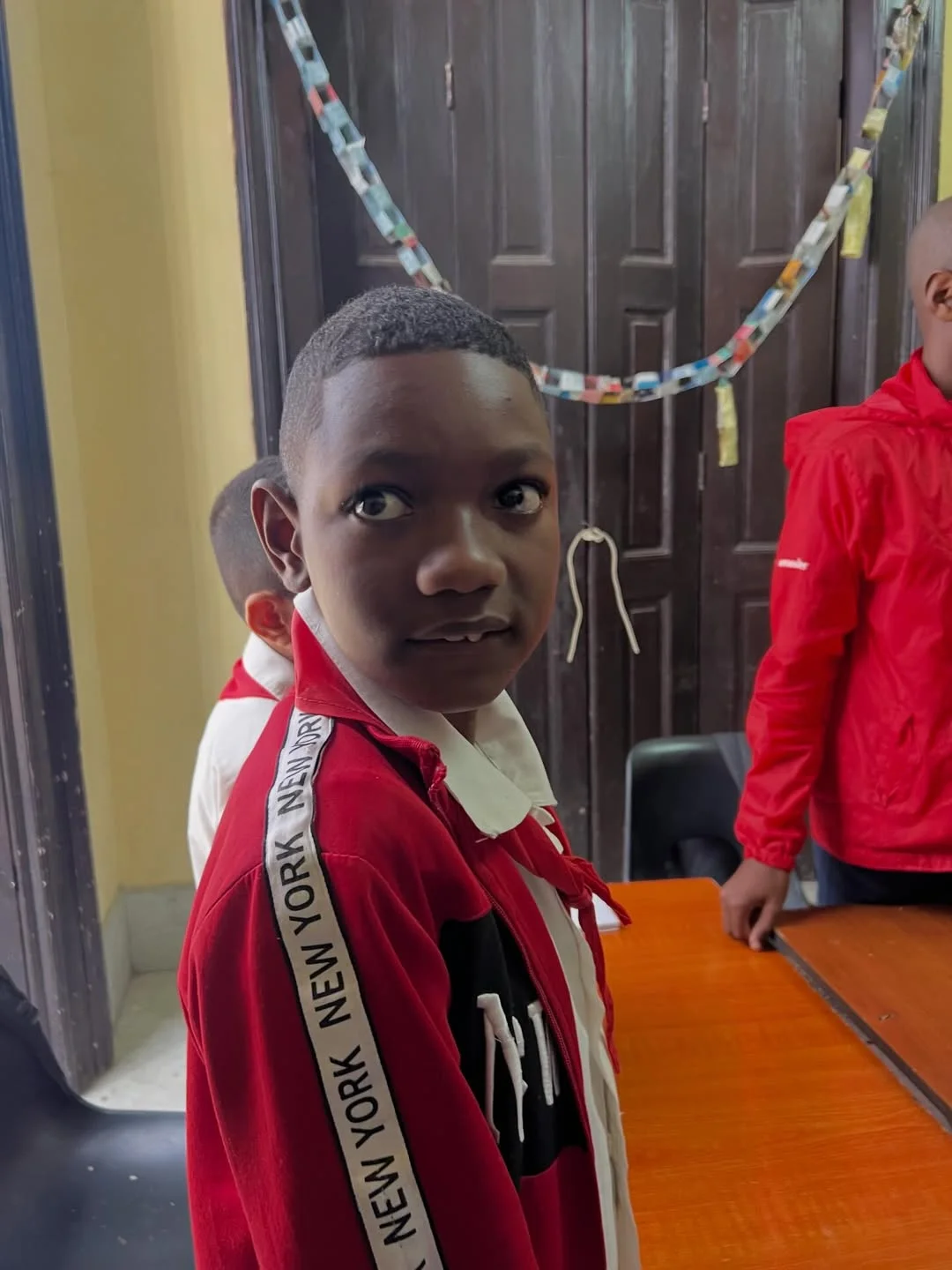 Photo by IFCO on March 28, 2026. May be an image of child, smiling, standing and text.