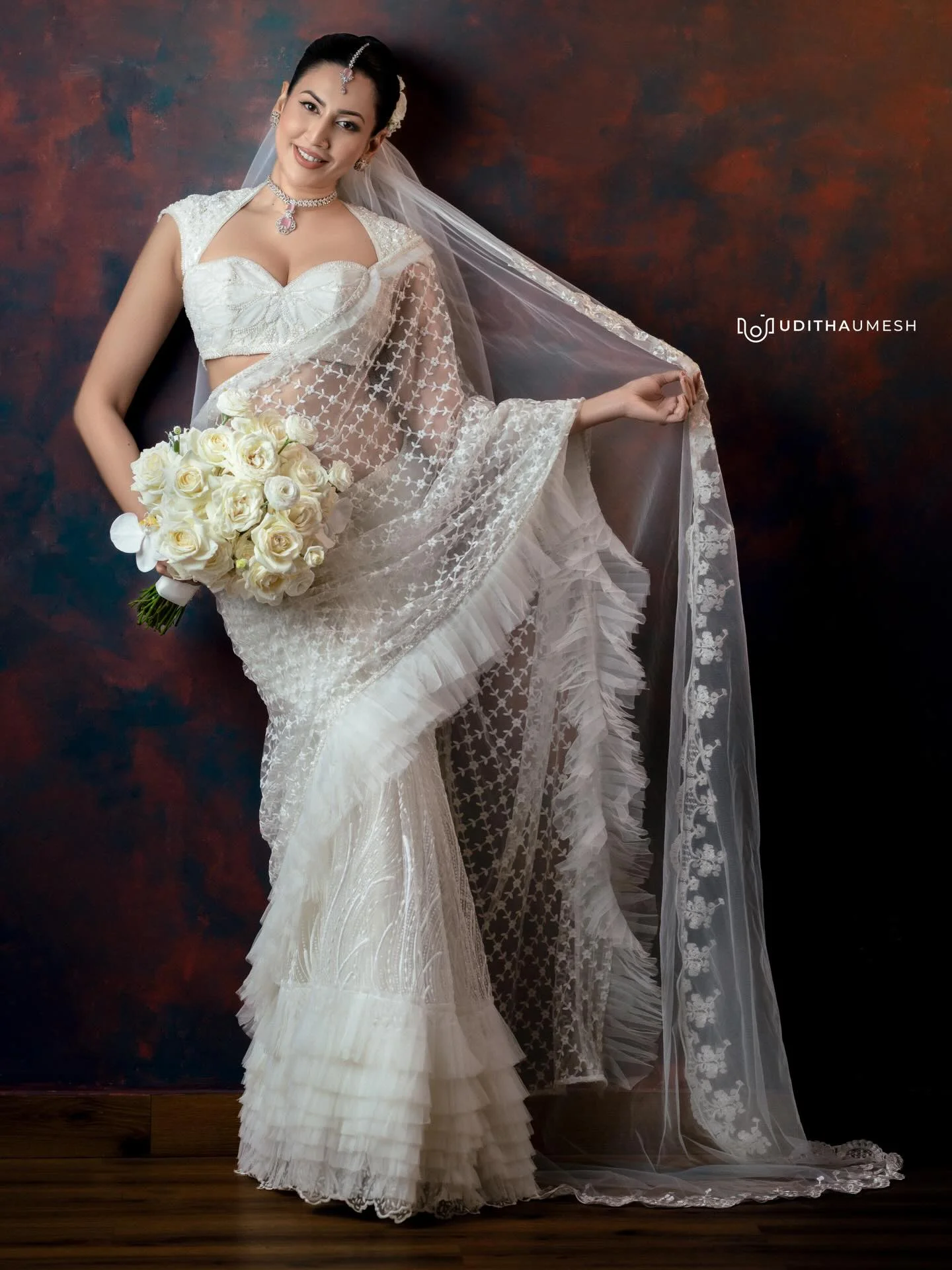 Photo by Amanda Silva on March 21, 2026. May be an image of gown, dress, prairie gentian, wedding and text that says 'DOOUDITHAUMESH ம'.