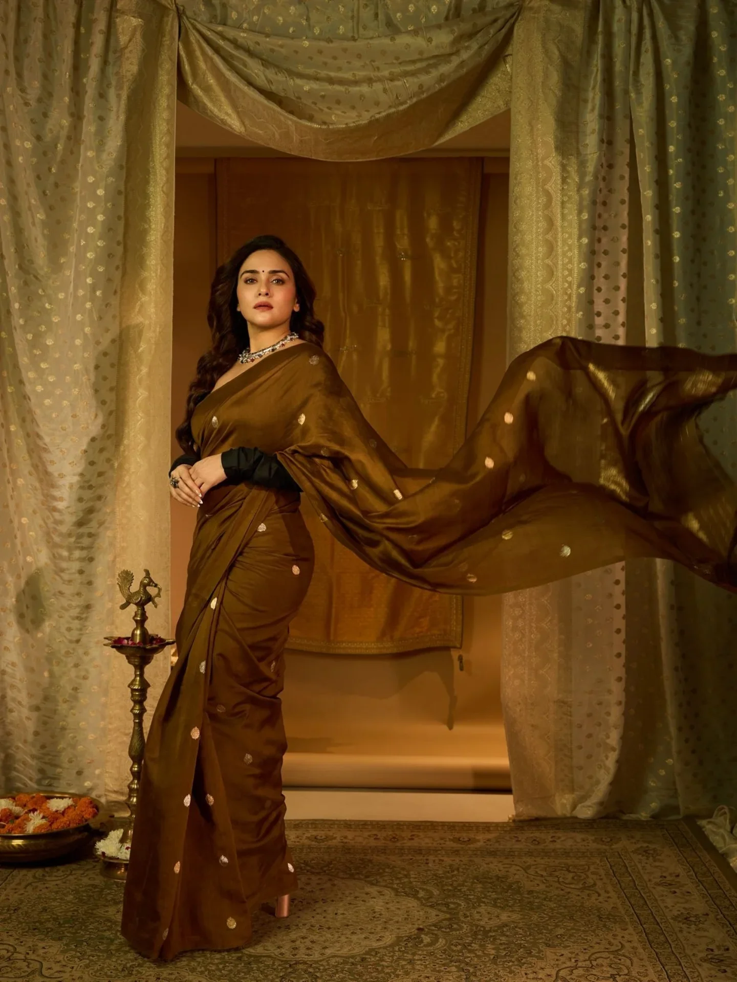 Photo shared by A M U L Y A by Amruta on March 24, 2026 tagging @amrutakhanvilkar, and @chandrakalm_jewellery. May be an image of gown, dress and text.